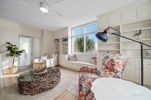 sitting room featuring light tile patterned floors, a textured ceiling, and a wealth of natural light