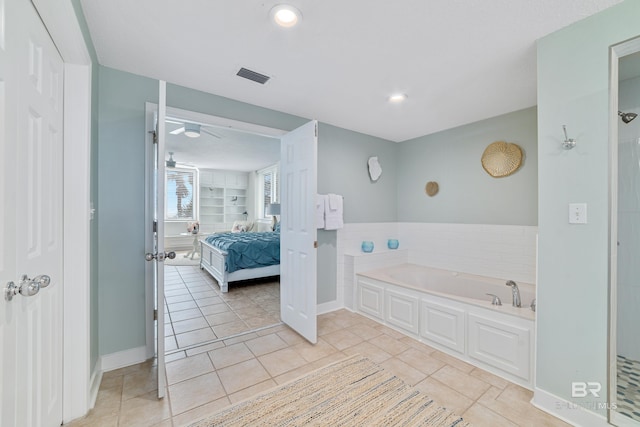 ensuite bathroom with visible vents, connected bathroom, baseboards, a garden tub, and tile patterned floors