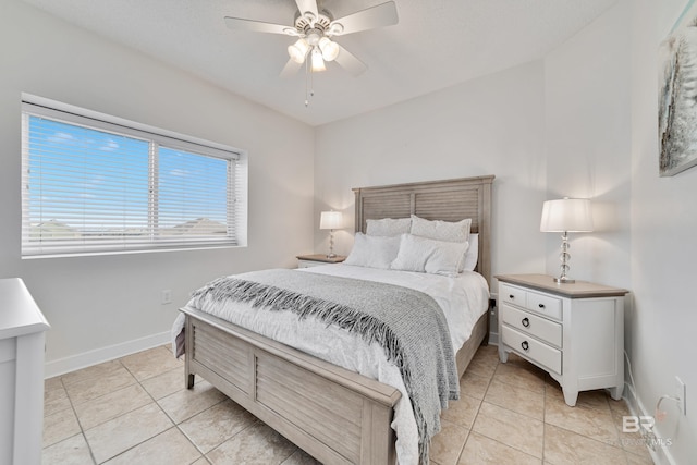 bedroom with light tile patterned flooring, a ceiling fan, and baseboards