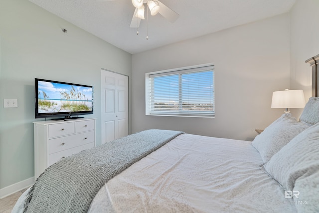 bedroom with baseboards, a closet, and ceiling fan