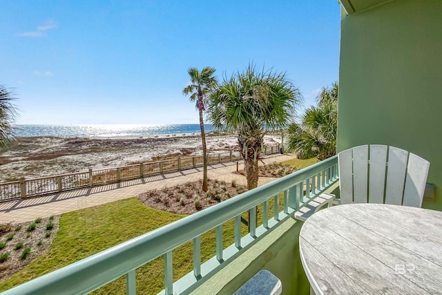 balcony featuring a beach view and a water view