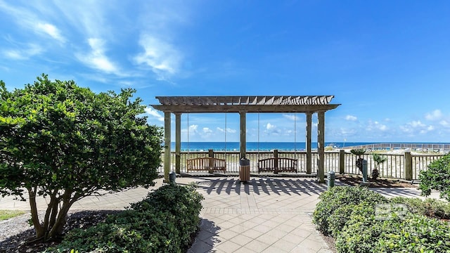 view of patio featuring a pergola and a water view