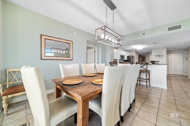 dining area featuring visible vents, baseboards, and light tile patterned flooring