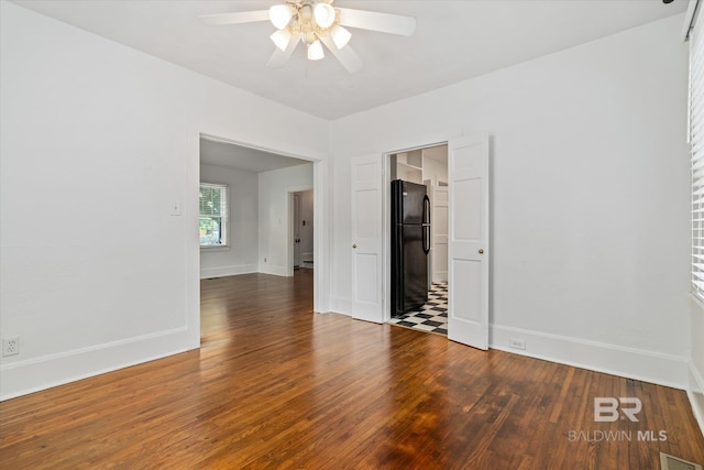 unfurnished room with ceiling fan and dark hardwood / wood-style floors