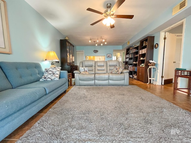 tiled living room featuring ceiling fan