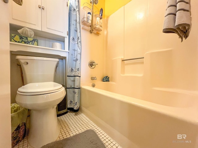 bathroom featuring shower / tub combo with curtain, tile patterned flooring, and toilet