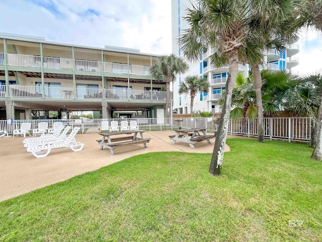 surrounding community featuring a patio area and a lawn