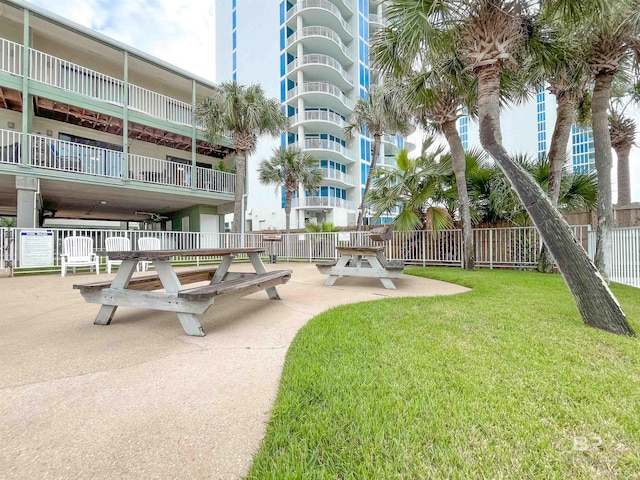 view of community featuring a yard and a patio area