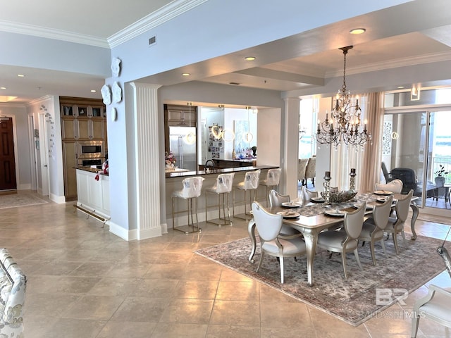 dining room featuring ornamental molding, sink, light tile patterned flooring, and a chandelier