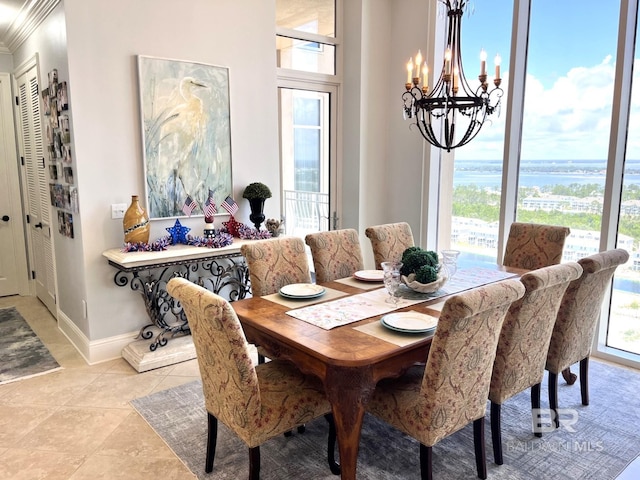 tiled dining space featuring a water view and a notable chandelier