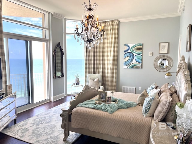 bedroom with an inviting chandelier, a water view, access to exterior, wood-type flooring, and ornamental molding