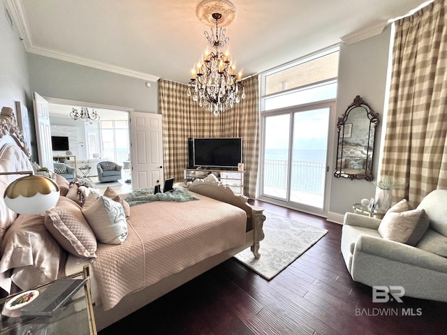 bedroom with an inviting chandelier, access to exterior, multiple windows, and wood-type flooring