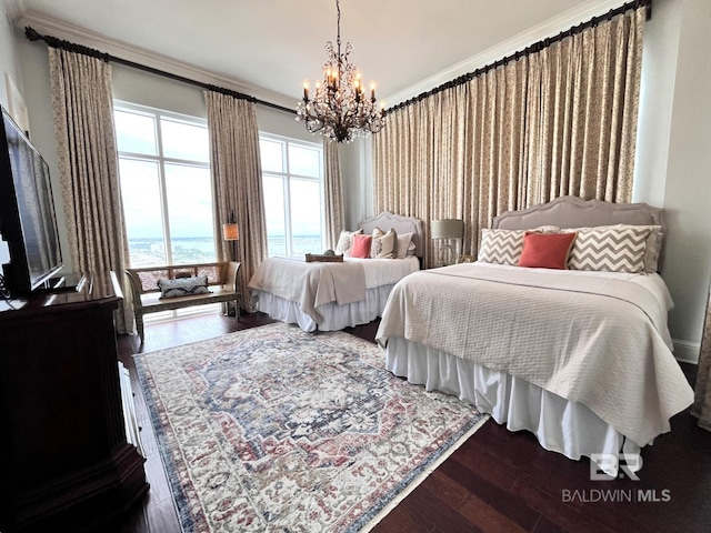 bedroom featuring ornamental molding, an inviting chandelier, a water view, and dark hardwood / wood-style floors