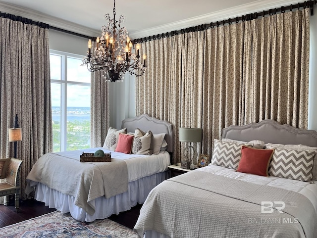 bedroom with an inviting chandelier, wood-type flooring, and ornamental molding