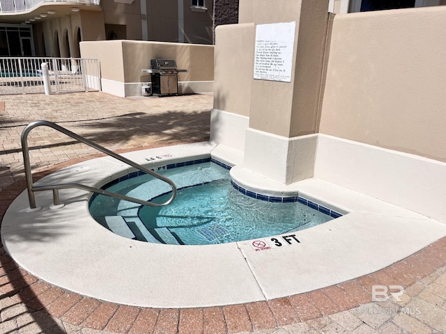 view of swimming pool featuring a patio area and a grill