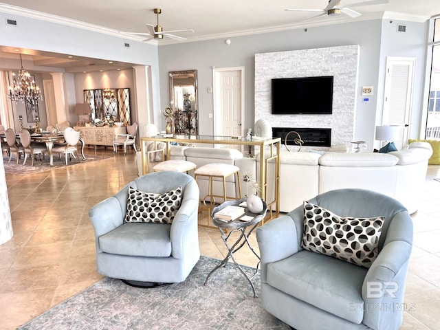 living room with a stone fireplace, ceiling fan with notable chandelier, ornamental molding, and light tile patterned floors