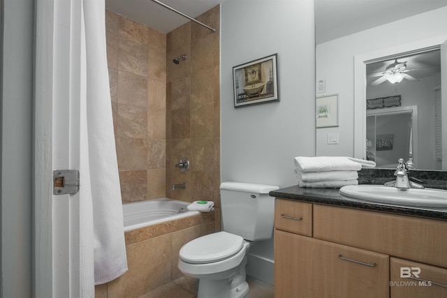 full bathroom featuring vanity, ceiling fan, shower / bath combo with shower curtain, tile patterned flooring, and toilet