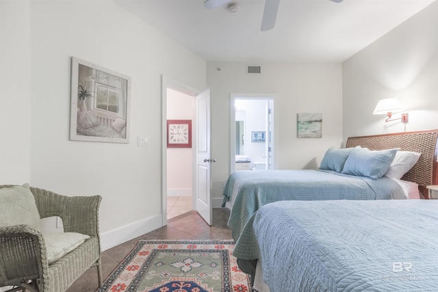 bedroom featuring tile patterned flooring, ceiling fan, and ensuite bath