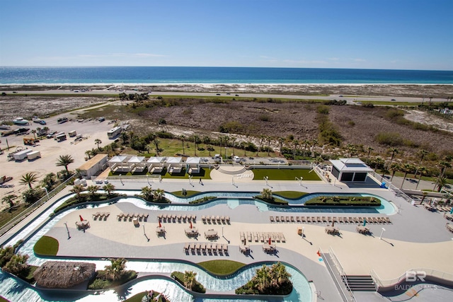 birds eye view of property featuring a beach view and a water view