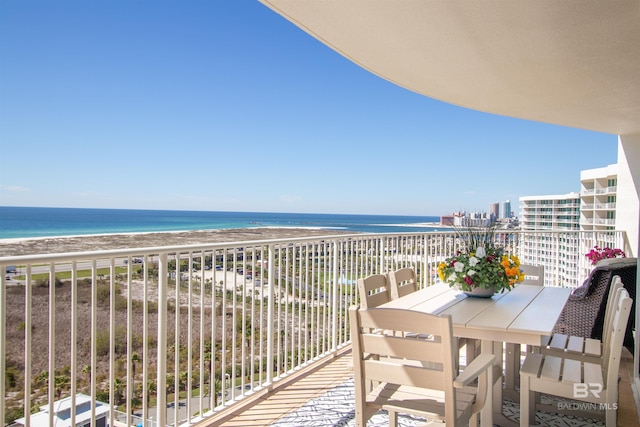 balcony featuring a water view and a beach view