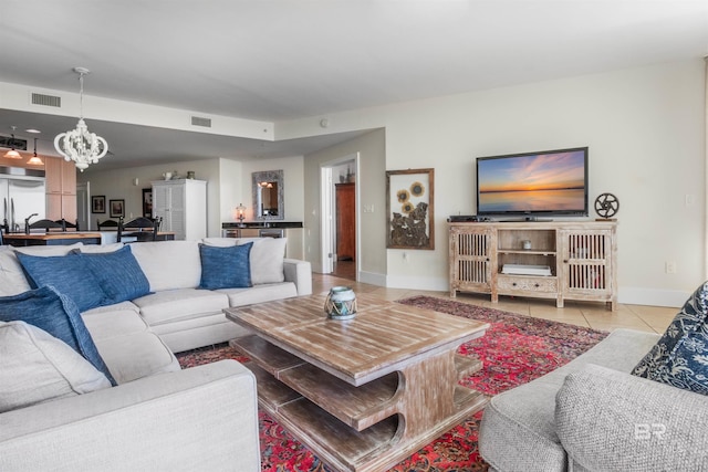 living room featuring light tile patterned floors and a chandelier