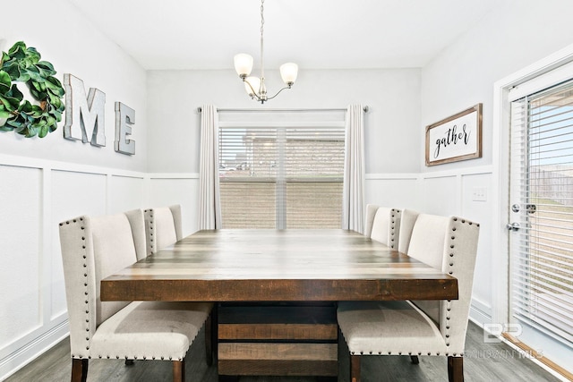 dining space featuring an inviting chandelier and dark wood-type flooring