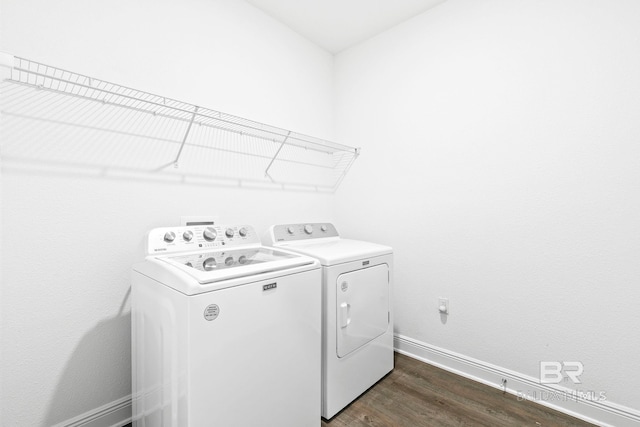 clothes washing area featuring dark wood-type flooring and independent washer and dryer