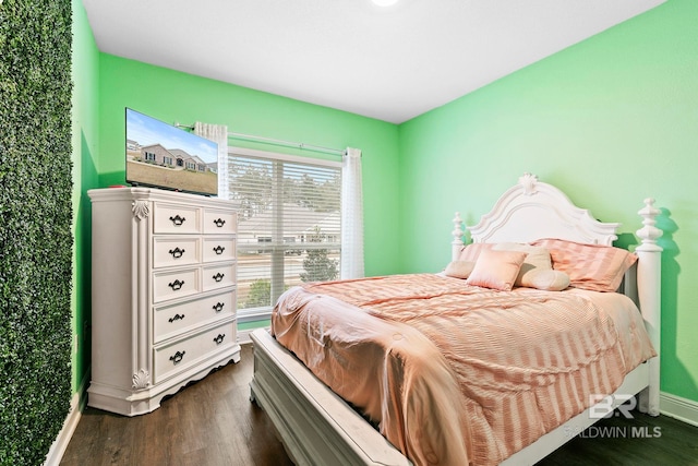 bedroom with dark hardwood / wood-style flooring