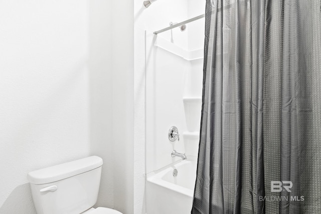 bathroom with toilet and shower / bath combo