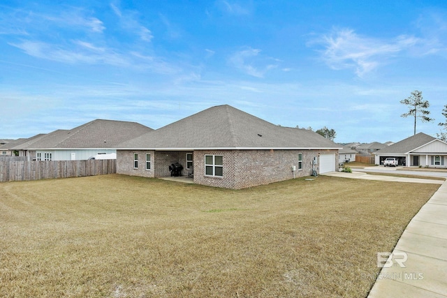 back of property featuring a yard and a garage