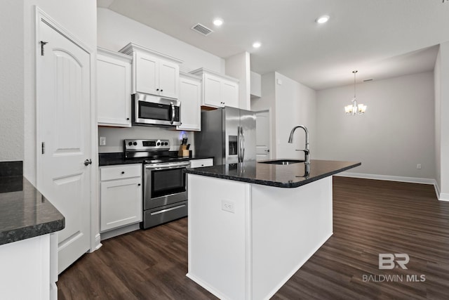 1311 Plymouth Dr, Foley, AL 36535 - kitchen featuring appliances with stainless steel finishes, a sink, dark wood-type flooring, a chandelier, and white cabinetry