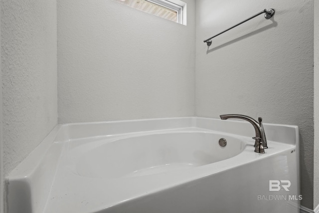 1311 Plymouth Dr, Foley, AL 36535 - full bathroom featuring a garden tub and a textured wall