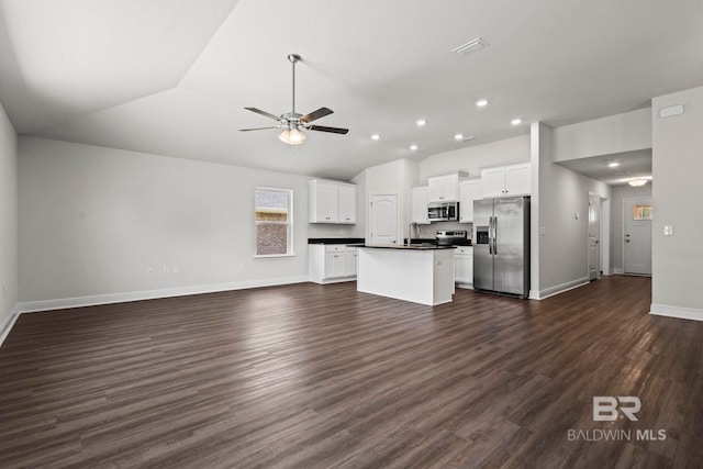 1311 Plymouth Dr, Foley, AL 36535 - unfurnished living room featuring vaulted ceiling, a ceiling fan, baseboards, dark wood finished floors, and a sink