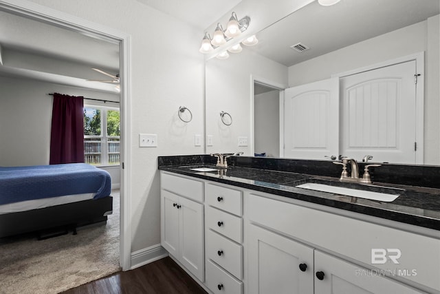 1311 Plymouth Dr, Foley, AL 36535 - ensuite bathroom with double vanity, wood finished floors, baseboards, and a ceiling fan