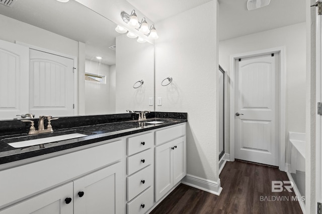 1311 Plymouth Dr, Foley, AL 36535 - bathroom with baseboards, wood finished floors, double vanity, and a shower stall