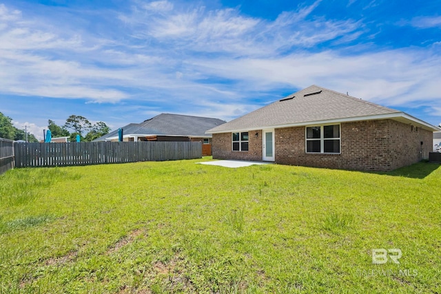 1311 Plymouth Dr, Foley, AL 36535 - back of property featuring a patio area, a shingled roof, brick siding, and central AC