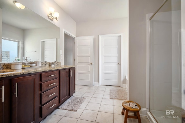 bathroom with walk in shower, vanity, and tile patterned floors