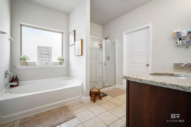 bathroom with tile patterned flooring, vanity, and separate shower and tub