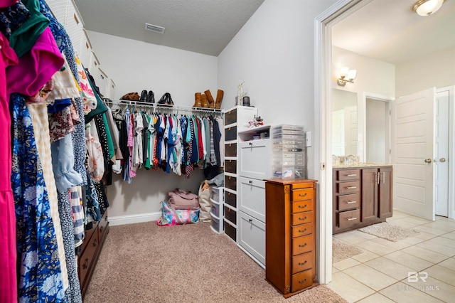 walk in closet featuring light tile patterned floors