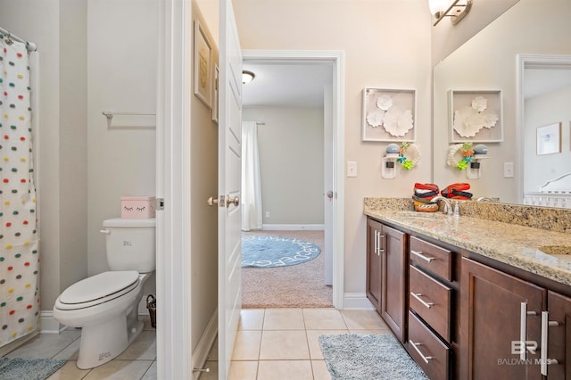 bathroom with tile patterned flooring, vanity, and toilet