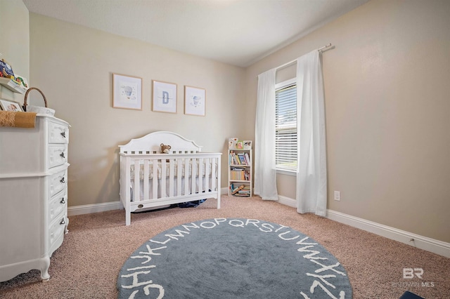 bedroom with a crib and carpet