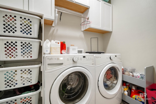 laundry room featuring cabinets and separate washer and dryer