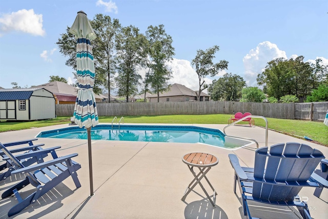 view of pool featuring a shed, a yard, and a patio