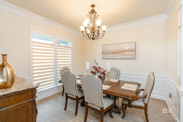 dining space with crown molding and a notable chandelier