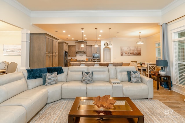 living room featuring ornamental molding, light tile flooring, and decorative columns