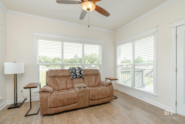 living room featuring light hardwood / wood-style floors, crown molding, and ceiling fan