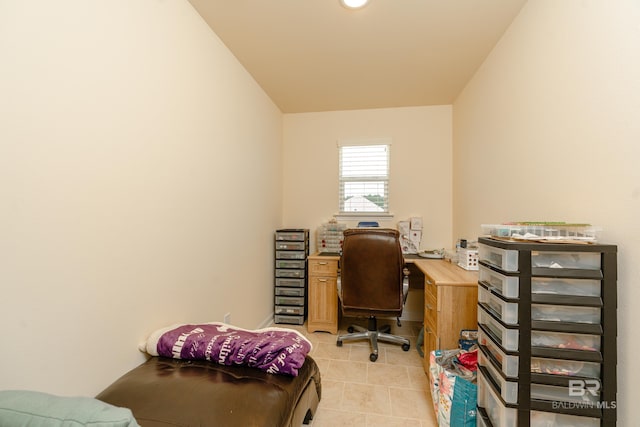 office space with tile floors and vaulted ceiling