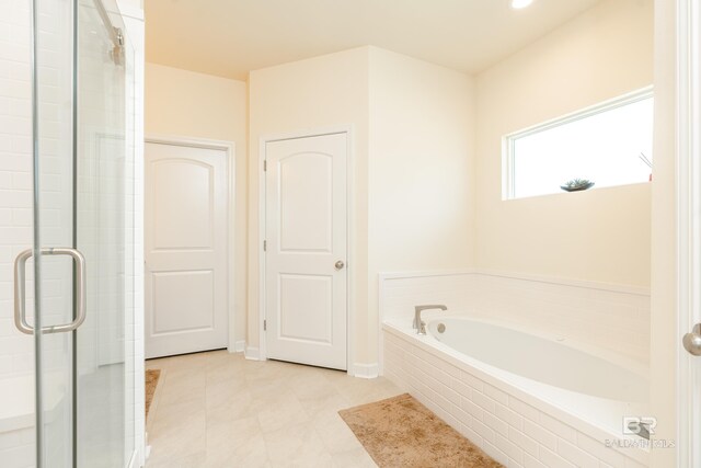 bathroom featuring separate shower and tub and tile floors