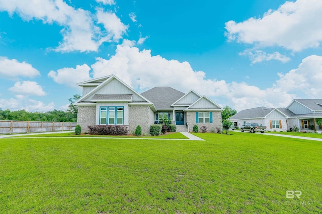 craftsman inspired home with a front lawn