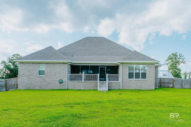 back of property featuring a yard